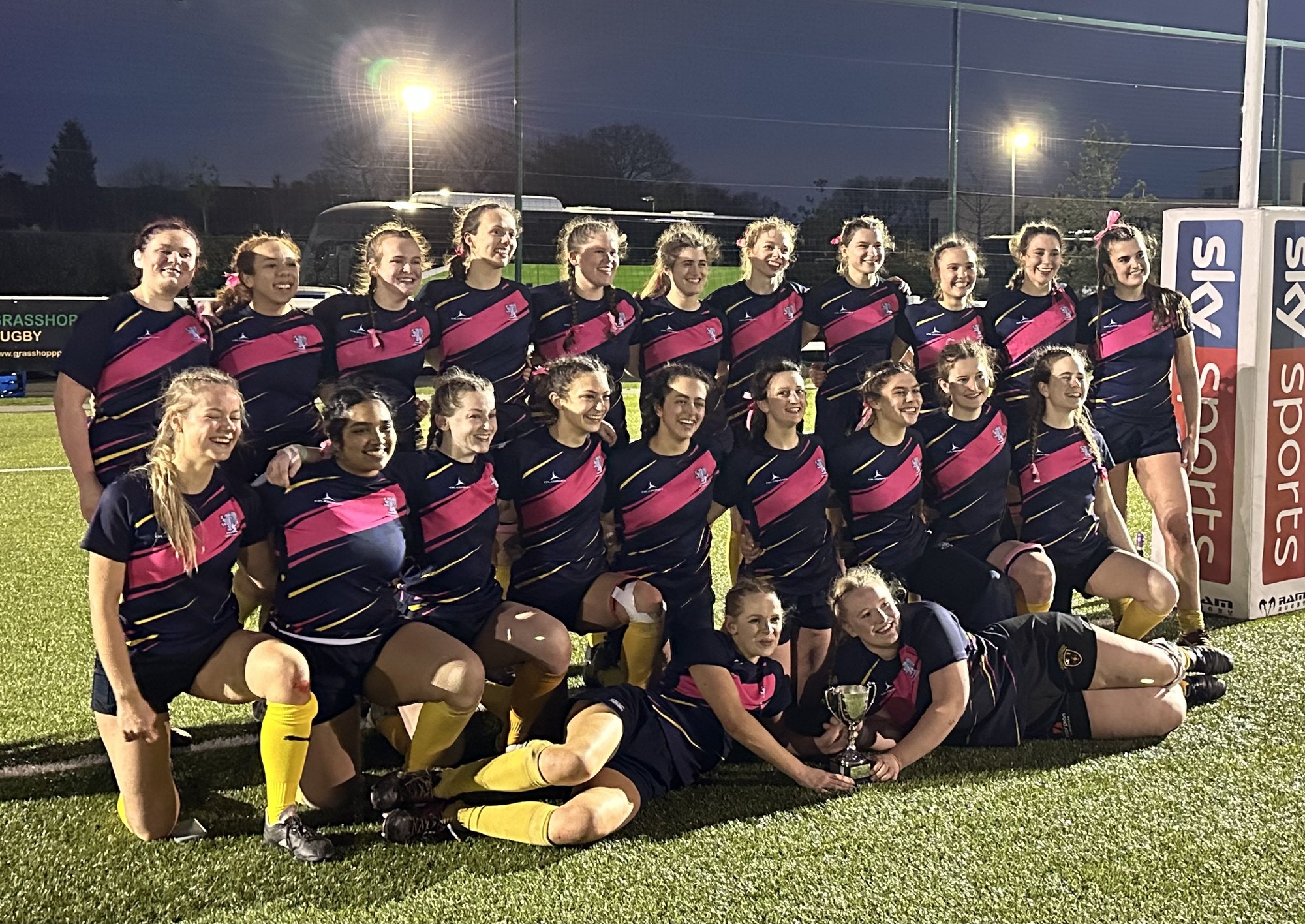 The Birds rugby team gathered together on a pitch.