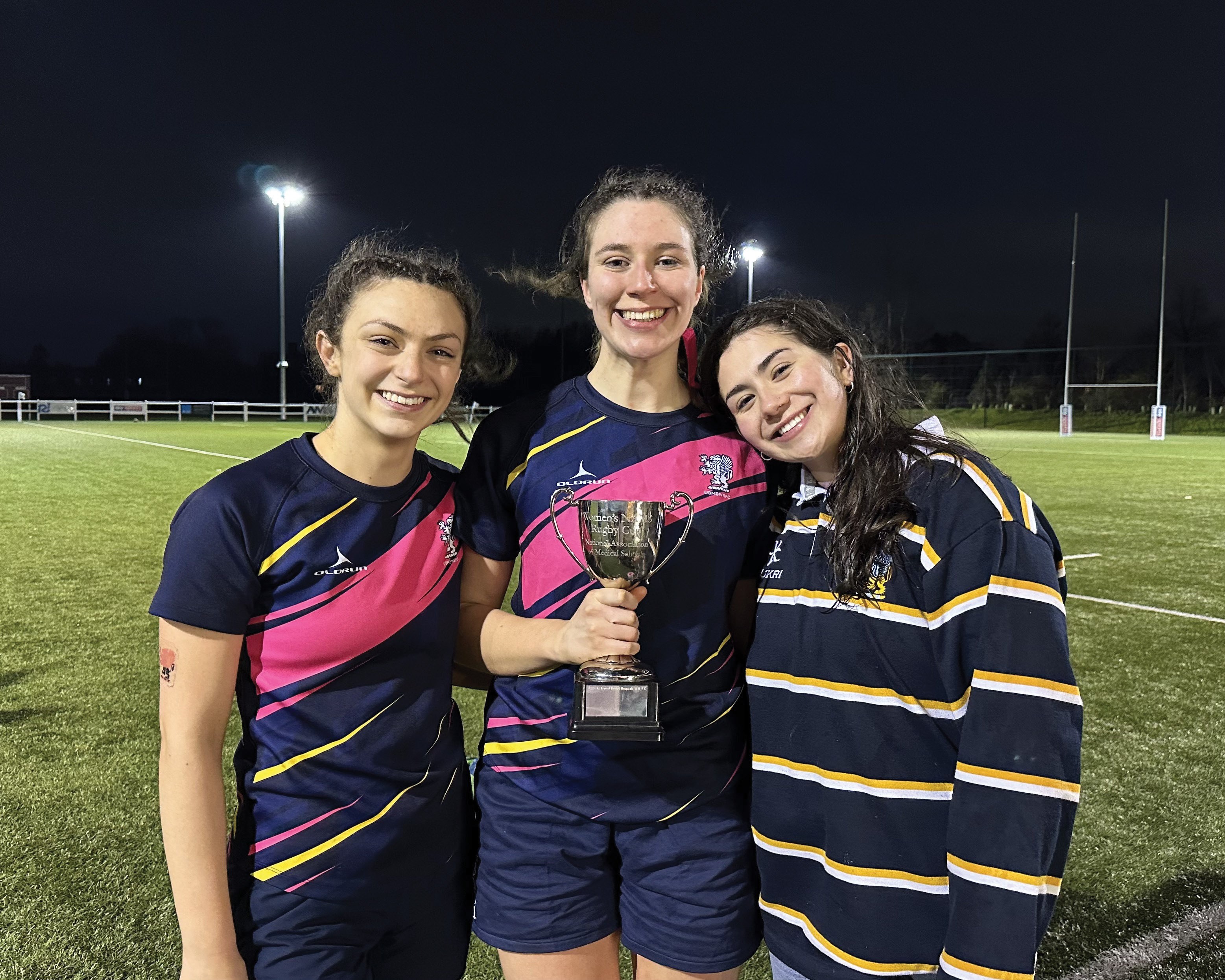Eliza with teammates holding a trophy